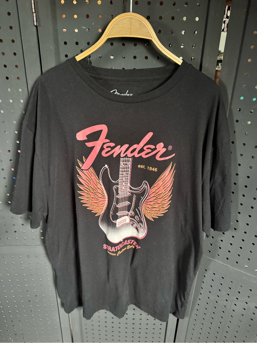 Fender Black Tee with Pink Logo and Orange-Pink Winged Guitar Graphic